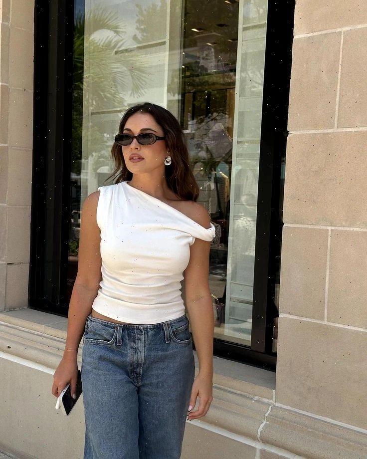 Another incarnation of femininity manifests in the one-shoulder knit top. Yet, caution is advised here: proper undergarments—whether silicone pasties or bandeaus—are paramount to pull off this look gracefully, given its exposure.